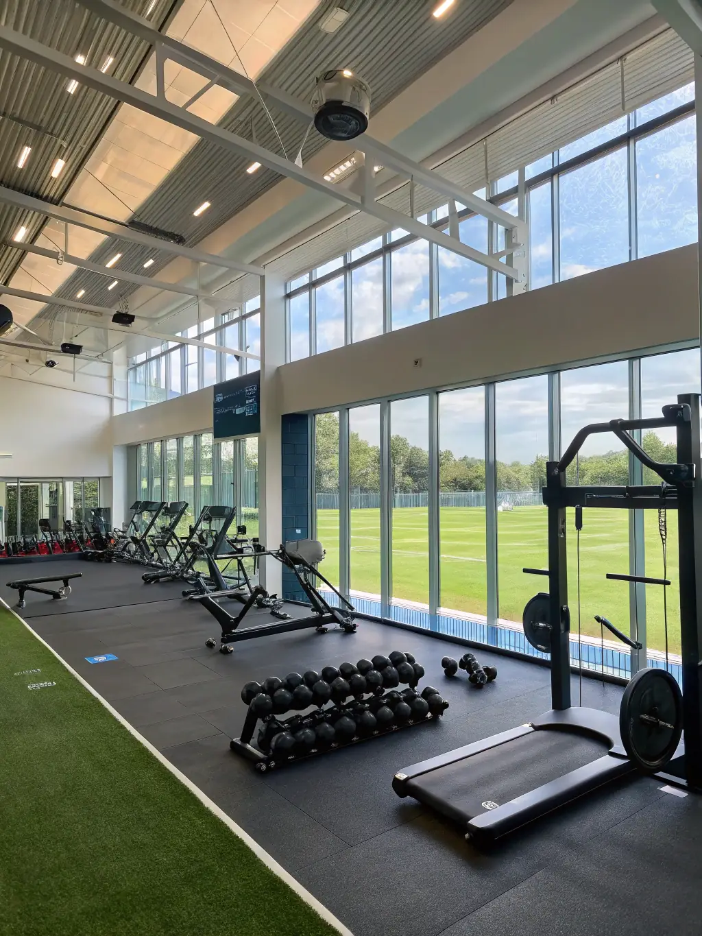A digital dashboard displaying real-time athlete performance data, including speed, agility, and recovery metrics, set against a modern sports facility background.